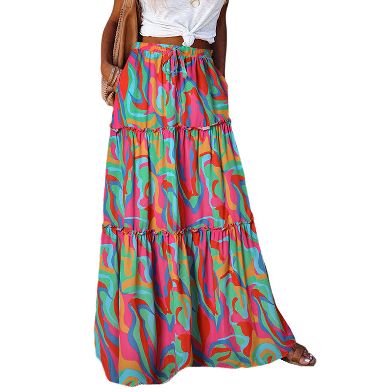 Tiered maxi dress with high waist and colorful abstract print in pink, teal, and yellow
