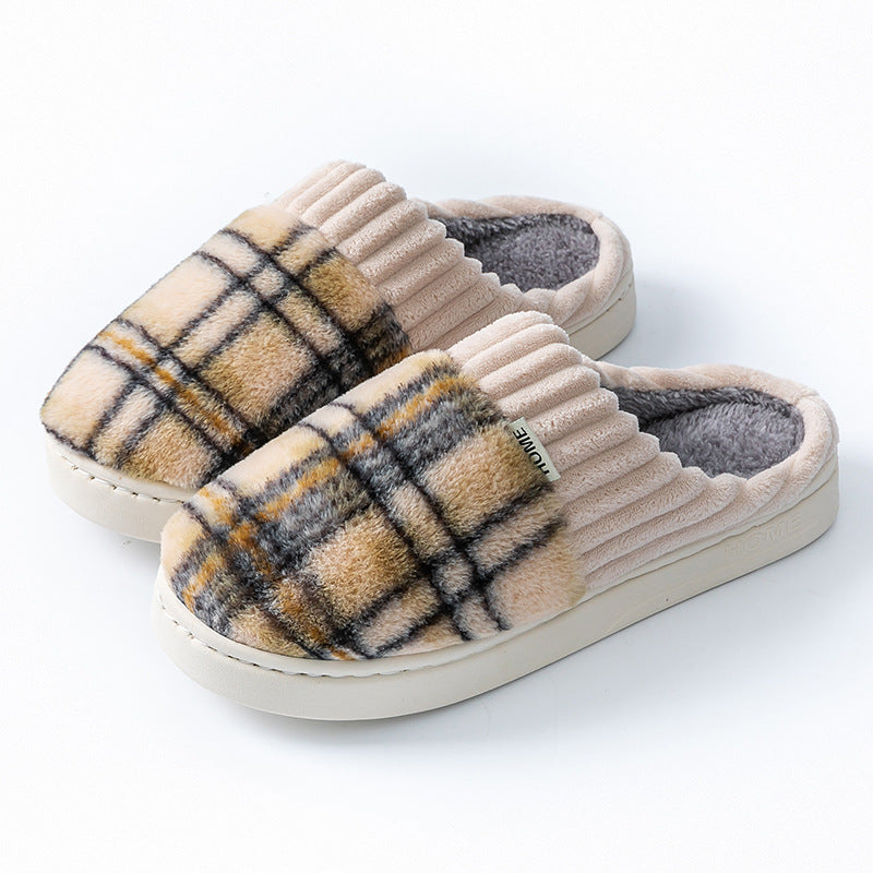 Plaid plush indoor slippers with ribbed cream trim; navy and tan plaid uppers with dark lining.