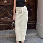 Beige high-waist denim skirt with front slit, button closure, and belt loops