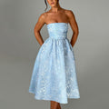 Blue satin jacquard tube top dress with fitted bodice and flared midi skirt.