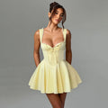 Light yellow corset-style mini dress with lace-trim straps and bow detail, flared skirt