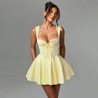 Light yellow corset-style mini dress with lace-trim straps and bow detail, flared skirt