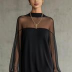 Black mini dress with sheer mesh sleeves and high neckline, ribbed collar