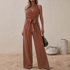 Rust orange high-waist sleeveless jumpsuit with V-neck, tie waist, and wide legs