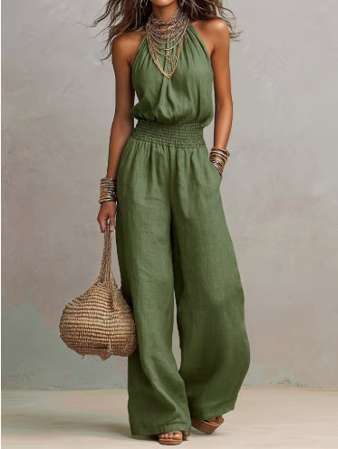 Green sleeveless jumpsuit with halter neck, smocked waist, and wide legs