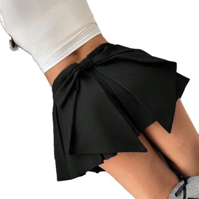 Black pleated mini skirt with large bow at the side waist