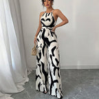 Zebra-print suspender jumpsuit with halter neckline, tie waist belt, wide-leg pants