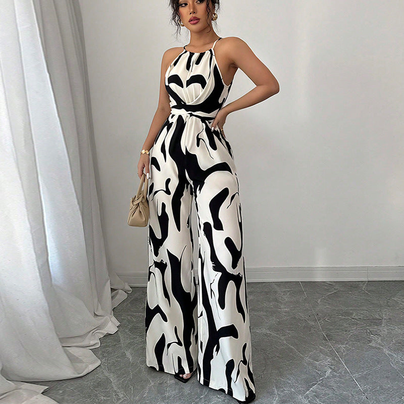 Zebra-print suspender jumpsuit with halter neckline, tie waist belt, wide-leg pants
