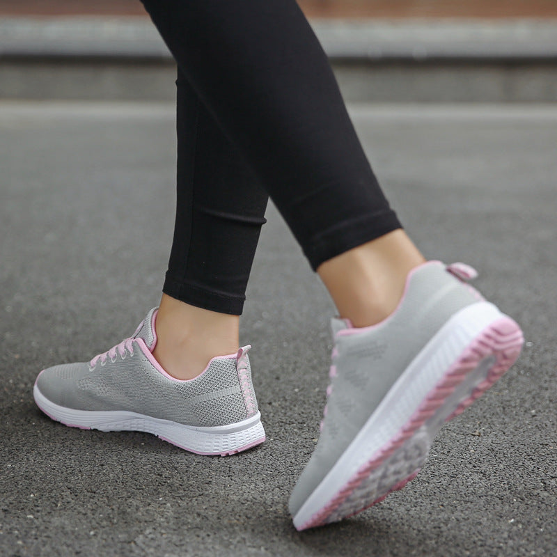 Light grey knit lace-up sports sneakers with pink-striped sole and white tread