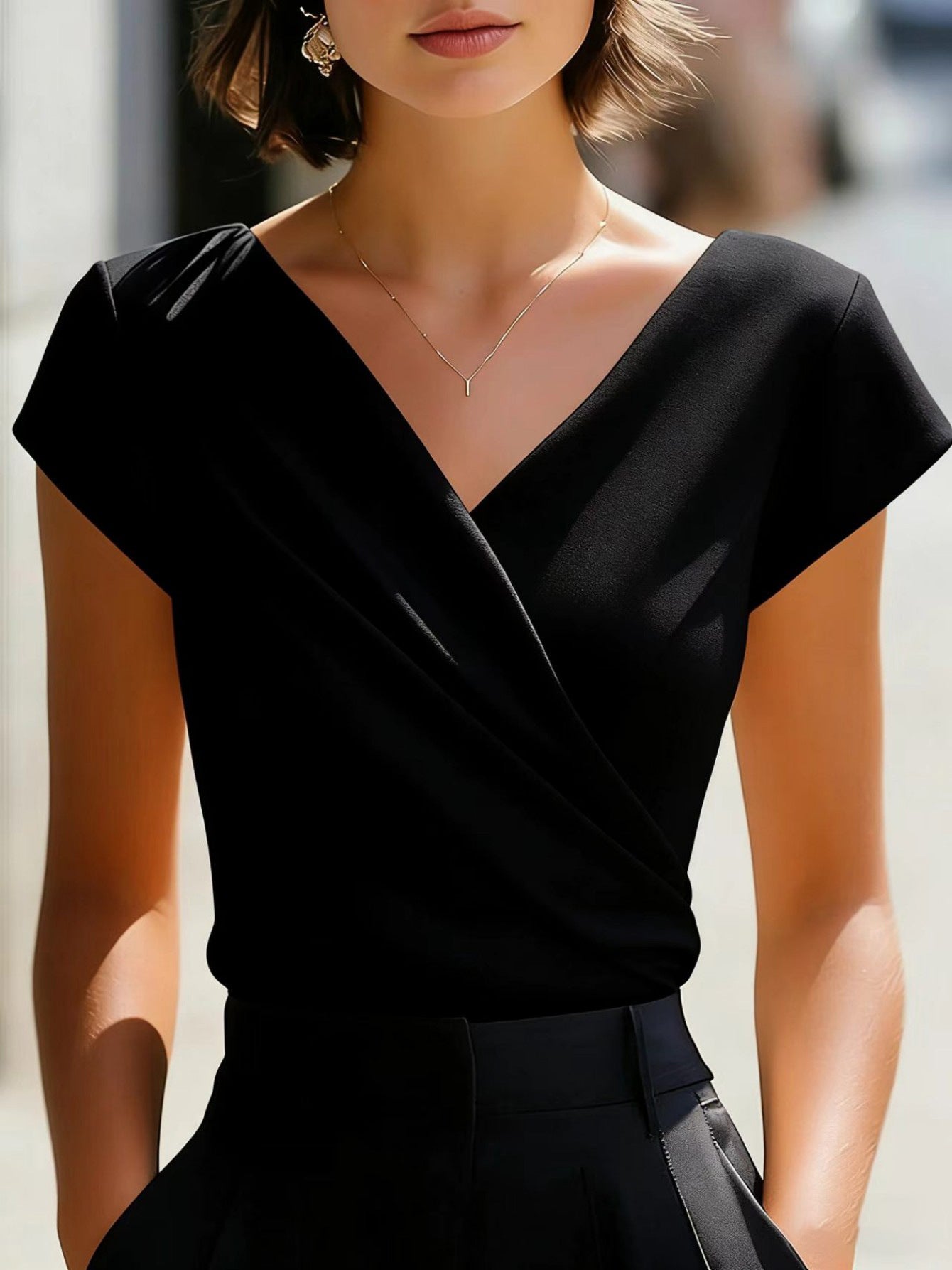 Black slim-fit V-neck t-shirt with short sleeves and diagonal wrap front