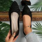 Black knit pointed-toe loafers with bow and gold beaded ankle bracelet