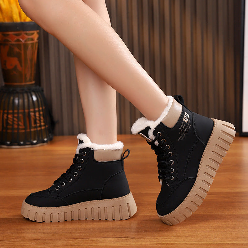 Black lace-up ankle snow boots with sherpa trim and thick ridged platform sole