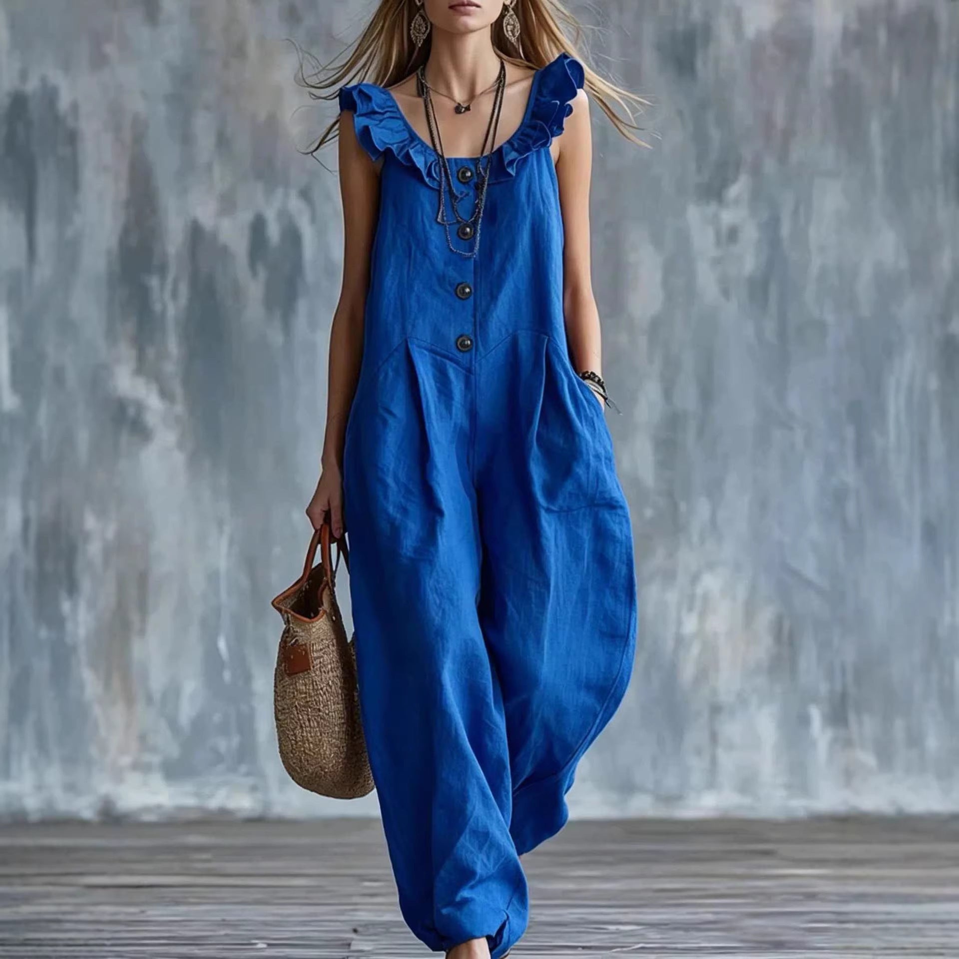 Blue sleeveless button-down jumpsuit with ruffled shoulder details and side pockets