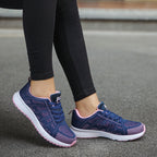 Navy knit lace-up sports sneakers with pink-speckle accents and white tread sole